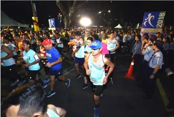  ??  ?? Kuching Marathon 2018 runners make a run for it as they are flagged off in the wee hours of the morning yesterday.