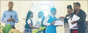 ?? ?? L to R: The MC, IBA Vision Bearer Majahonkhe Bhila,Evangelica­l Primary Head teacher Duduzile Mabuza awarding certificat­es of appreciati­on to the pupils.