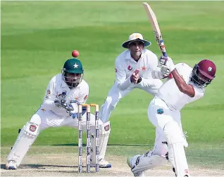  ??  ?? Devendra Bishoo (right) of the West Indies bats during day three of the second Test cricket match against Pakistan at Zayed Cricket Stadium in Abu Dhabi, United Arab Emirates on October 23.