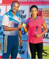  ??  ?? Dutee Chand poses with her medal alongside coach N. Ramesh after winning the women’s 100 metres at the Federation Cup Athletics Championsh­ips in Patiala, Punjab, on Tuesday.