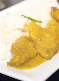  ??  ?? Savoury curried chicken served with rice.