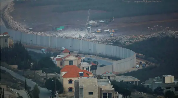  ?? (Ronen Zvulun/Reuters) ?? ISRAELI DRILLING EQUIPMENT is seen next to the border with Lebanon, near the Lebanese village of Kafr Kila, seen from Israel’s side on December 4.