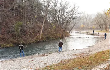  ?? (NWA Demorcrat-Gazette/Flip Putthoff) ?? Anglers fish at Roaring River State Park on Nov. 13 during opening day of the park’s catch and release trout season. Fishing is allowed with flies only from 8 a.m. to 4 p.m. Friday through Monday. The season opens each year on the second Friday of November and closes at 4 p.m. on the second Monday in February. Anglers may catch an unlimited number of trout, but all must be released.