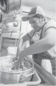  ??  ?? Blanca Ramirez prepares corn to make masa for tortillas at Eight Row Flint, which invested in a commercial corn grinder and skilled workers.