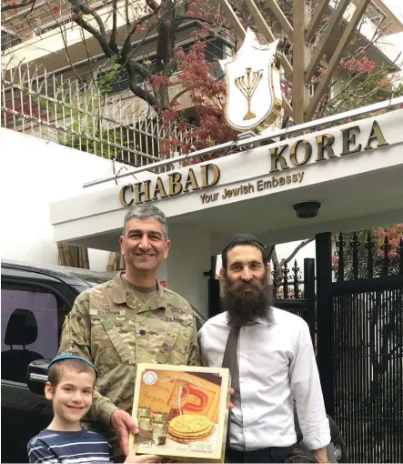  ?? (Photos: Courtesy) ?? AT CHABAD Korea, Rabbi Osher Litzman gifts a box of shmurah matzah to US Chaplain Rabbi Henry Soussan.