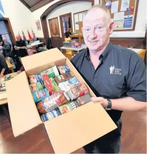  ??  ?? CRACKING EFFORT Ian shows off one of the hampers given to veterans. Picture: Phil Dye