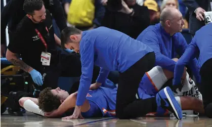  ?? Photograph: Christophe­r Hanewincke­l/ USA Today Sports ?? Florida Gators head coach Todd Golden attends to Micah Handlogten after his injury on Sunday.