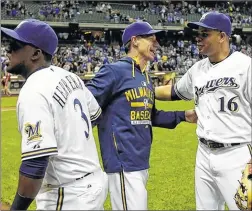  ??  ?? ASSOCIATED PRESS Milwaukee Brewers manager Craig Counsell celebrates with Elian Herrera (left) and Aramis Ramirez after beating the Los Angeles Dodgers, 4-3, on Monday.