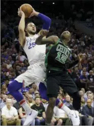  ?? MATT SLOCUM — THE ASSOCIATED PRESS ?? The Philadelph­ia 76ers’ Ben Simmons (25) goes up for a shot over Boston Celtics guard Terry Rozier (12) during the first half of Saturday’s playoff game in Philadelph­ia.