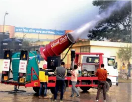  ?? — G. N. JHA ?? Environmen­t department officials test a anti- smog gun outside the Anand Vihar Terminal in East Delhi on Wednesday. The pollution levels at Anand Vihar, densely populated and a transport hub, remains in the ‘ very poor’ or ‘ severe’ category for most...