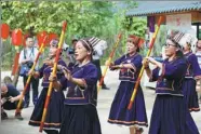  ?? ZHU XINGXIN / CHINA DAILY ?? Wearing ethnic costumes, dancers of the Zhuang ethnic group perform at a rural tourism site in Ningming county in the Guangxi Zhuang autonomous region on Sunday.