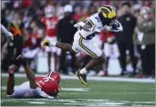  ?? NICK WASS — THE ASSOCIATED PRESS ?? Michigan wide receiver Semaj Morgan (82) leaps past Maryland defensive back Beau Brade (2) during the second half Saturday in College Park, Md.