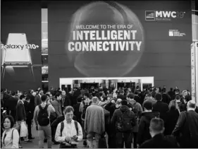  ?? PHOTO/EMILIO MORENATTI AP ?? In this Feb. 25, 2019, photo, attendees walk to enter at the Mobile World Congress wireless show, in Barcelona, Spain.