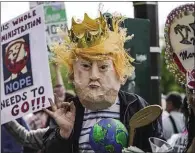  ??  ?? Protesters mock President Trump in May 2017