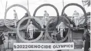  ?? ASHWINI BHATIA AP ?? In February 2021, Tibetan exiles in Dharmsala, India, use the Olympic rings as a prop to protest against the holding of 2022 Winter Olympics in Beijing.