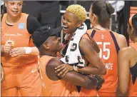  ?? Jessica Hill / Associated Press ?? The Connecticu­t Sun’s Courtney Williams is lifted in the air by her father Don Williams after a playoff win over the Los Angeles Sparks.