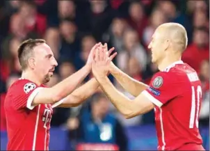  ?? AFP ?? Bayern Munich midfielder­s Franck Ribery (left) and Arjen Robben celebrate their second goal in the Champions League quarterfin­al first-leg match with Sevilla on Tuesday.