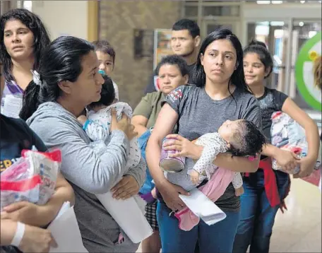  ?? LOREN ELLIOTT AFP/Getty Images ?? TWO-THIRDS of American voters oppose the family separation policy, a national poll says. Above, freed immigrants in McAllen, Texas.