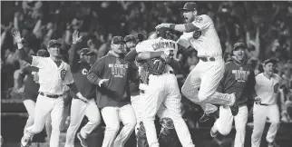  ?? DAVID J. PHILLIP/ THE ASSOCIATED PRESS ?? Chicago Cubs players celebrate after advancing to the World Series past the the Los Angeles Dodgers. The Cubs went on to beat Cleveland for the big prize.