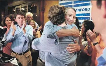  ?? Wade Spees Post and Courier ?? REPUBLICAN Rep. Mark Sanford hugs his son after addressing supporters in Mount Pleasant, S.C., about his primary election defeat. Sanford sometimes criticized President Trump, but he typically voted with him.