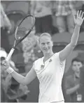  ??  ?? Alison Van Uytvanck celebrates defeating Garbine Muguruza in Thursday’s women's singles match at Wimbledon.