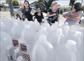  ?? Luis Sinco Los Angeles Times ?? COMPTON residents pick up donated bottled water Tuesday amid concerns about the city’s tap water.