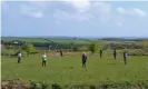  ?? Historic England/CAU/PA ?? Volunteers stand on the seven pits found at Castilly Henge near Bodmin. Photograph: