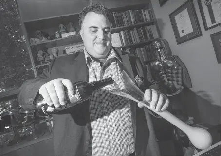  ?? DAX MELMER ?? Max Nelson, associate professor of Greek and Roman studies at the University of Windsor, pours a glass of beer in his office. He will be part of a free beer symposium at the university on Sept. 30, and will teach a beer course at ElderColle­ge in October.