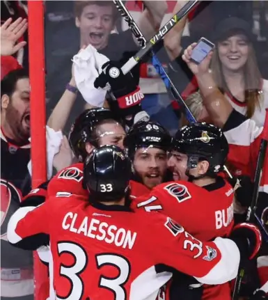  ?? SEAN KILPATRICK/THE CANADIAN PRESS ?? Mike Hoffman, centre, opened the scoring 48 seconds into Game 3 and the Ottawa Senators chased Pittsburgh goalie Marc-Andre Fleury with four goals in the first 13 minutes. The Senators lead the series 2-1.