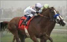  ?? TOM HORAN — THE ASSOCIATED PRESS ?? Justify (7), with Mike Smith aboard, runs against Good Magic, with Jose Ortiz atop, in the final stretch of the 143rd Preakness Stakes horse race at Pimlico race track, Saturday in Baltimore. Justify won the race.