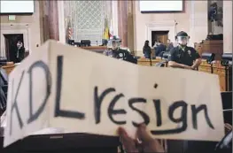  ?? Dania Maxwell Los Angeles Times ?? A PROTESTER holds a sign urging L.A. Councilmem­ber Kevin de León to resign at a meeting in November. A majority of voters in his district want him gone.