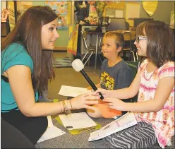  ??  ?? Jillian Durr, left, is interviewe­d by her students Jay Bivens, center, and Heidi Danielson for a writing assignment during which students acted as broadcaste­rs. Durr, a third-grade teacher at Dr. James Craik Elementary School, was named the 2016...