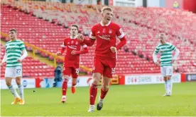  ??  ?? Lewis Ferguson celebrates scoring an injury-time penalty, his second goal of the game, to secure a 3-3 draw for Aberdeen at home to Celtic. Photograph: Stephen Dobson/ProSports/ Shuttersto­ck