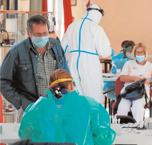  ??  ?? Ciudadanos se someten a pruebas de coronaviru­s en la localidad sevillana de Coria del Río