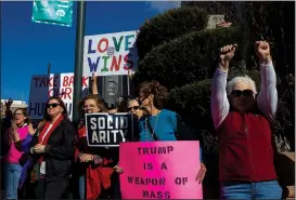  ?? NWA Democrat-Gazette/CHARLIE KAIJO ?? Supporters cheer Saturday during the rally at Fayettevil­le’s Town Center.