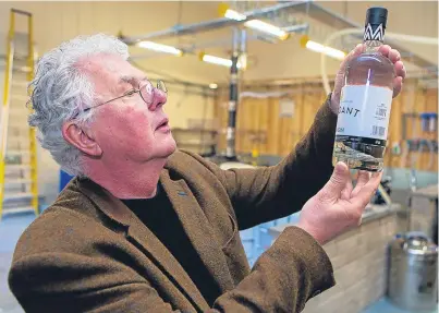  ?? Picture: Steven Brown. ?? Andrew MacKenzie inspects a bottle of Verdant gin after production at the Edward Street Mill, the first new distillery in Dundee for 200 years.