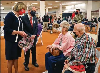  ?? BILL LACKEY / STAFF ?? Gov. Mike DeWine and his wife, Fran, talk with Thomas Whitaker and his wife, Judy, as they wait the required 15 minutes after getting their second COVID vaccine shot Thursday.