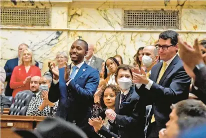  ?? BARBARA HADDOCK TAYLOR/BALTIMORE SUN ?? House Majority Whip Jazz Lewis, left, and Majority Leader Marc Korman, along with other delegates and family members applaud in the House of Delegates chamber Wednesday on the first day of the legislativ­e session in Annapolis.