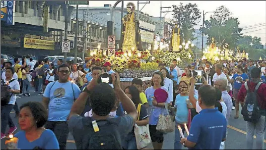  ?? MIGUEL DE GUZMAN ?? Thousands of devotees take part in the annual procession of Our Lady of La Naval de Manila in the vicinity of Sto. Domingo Church in Quezon City yesterday.