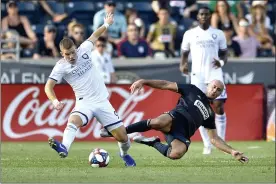  ?? DERIK HAMILTON — THE ASSOCIATED PRESS ?? Union defender Aurelien Collin, right, pressuring Orlando City’s Chris Mueller during a game in July 2019, has been re-signed by the club for 2021.