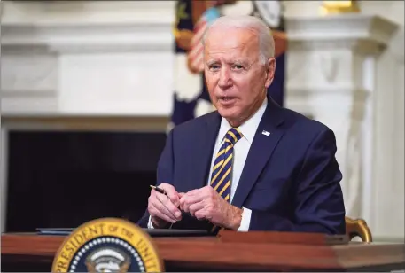  ?? Associated Press ?? President Joe Biden pauses after signing an executive order Wednesday relating to U.S. supply chains, in the State Dining Room of the White House.