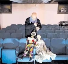  ?? Photo — AFP ?? Grilli holds two puppets in the parterre at the ‘Alfa Theatre’ in Turin.