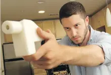  ?? JAY JANNER, ASSOCIATED PRESS ?? Cody Wilson shows the first completely 3D-printed handgun, the Liberator, at his home in Austin, Texas.