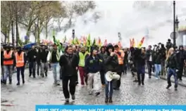  ??  ?? PARIS: SNCF railway workers hold CGT union flags and chant slogans as they demonstrat­e as part of their strike over plans to overhaul the national state-owned railway company SNCF, yesterday near the National Assembly in Paris. — AFP