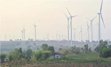  ?? PEERAWAT JARIYASOMB­AT ?? Wind turbines are seen at Nakhon Ratchasima’s Huai Bong Wind Farm, a leading renewal energy company.