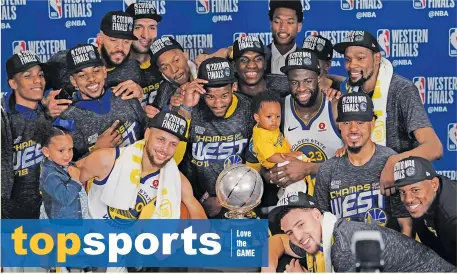  ?? AP PHOTO/DAVID J. PHILLIP ?? WEST CHAMPS. The Golden State Warriors pose with their trophy after defeating the Houston Rockets in Game 7 of the NBA basketball Western Conference finals, Monday, May 28, 2018, in Houston.