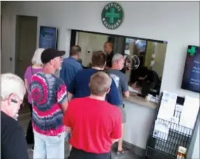  ?? ASSOCIATED PRESS FILE PHOTO ?? In this July 31, 2015, file photo, people line up to be among the first in Nevada to legally purchase medical marijuana at the Silver State Relief dispensary in Sparks, Nev.