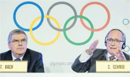  ??  ?? IOC president Thomas Bach, left, and Samuel Schmid, president of the IOC Inquiry Commission announce at a news conference Tuesday in Lausanne, Switzerlan­d, that Russian athletes must compete as neutrals at the Pyeongchan­g Olympics.