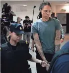  ?? ALEXANDER ZEMLIANICH­ENKO/AP ?? Brittney Griner is taken to court Thursday outside Moscow. Before she was sentenced she made a plea for leniency.