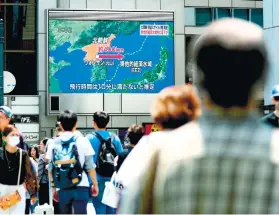  ?? KYODO NEWS VIA AP ?? ANOTHER MISSILE LAUNCH. People in Osaka, Japan walk near a screen that reports North Korea’s missile launch.